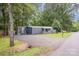 This lovely single-story home features new gravel, well-kept lawn, and a charming covered front porch, with mature trees surrounding the house at 870 Family Dr, Midland, NC 28107