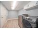 Laundry room with stainless washer and dryer, tile floor at 870 Family Dr, Midland, NC 28107
