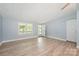 Light filled living room featuring neutral vinyl flooring and light blue walls, offering a clean and serene atmosphere at 870 Family Dr, Midland, NC 28107