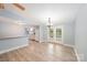 Spacious living area featuring neutral vinyl flooring and light blue walls, showcasing an open layout with the kitchen at 870 Family Dr, Midland, NC 28107