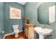 Charming powder room with elegant fixtures, decorative mirror, and wooden flooring at 10237 Broken Stone Ct, Charlotte, NC 28214