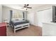 Neutral toned bedroom with a ceiling fan, double closets, and a large window at 10237 Broken Stone Ct, Charlotte, NC 28214