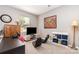 Well-lit bonus room with large clock, desk, TV, gaming chairs and toy storage at 10237 Broken Stone Ct, Charlotte, NC 28214
