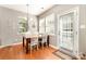 Bright dining area with hardwood floors, table, chairs, chandelier, and natural light at 10237 Broken Stone Ct, Charlotte, NC 28214