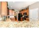 Open kitchen with hardwood floors, granite counters, wood cabinets and view to dining room at 10237 Broken Stone Ct, Charlotte, NC 28214