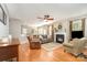Comfortable living room with fireplace, hardwood flooring, ceiling fan, and lots of light at 10237 Broken Stone Ct, Charlotte, NC 28214