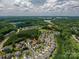 Aerial view of a neighborhood showcasing beautiful homes and surrounding landscape near a lake at 104 Wingstem Ct, Mooresville, NC 28117
