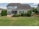Spacious backyard with a screened porch, patio, and lush green lawn, perfect for outdoor living at 104 Wingstem Ct, Mooresville, NC 28117
