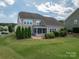 Large backyard with green grass, privacy fence, and a screened-in porch for enjoying outdoor space at 104 Wingstem Ct, Mooresville, NC 28117