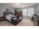 Comfortable bedroom featuring a bed, sofa, and accents at 104 Wingstem Ct, Mooresville, NC 28117