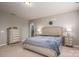 Neutral bedroom with a queen bed, side tables with lamps, and a view to the hallway at 104 Wingstem Ct, Mooresville, NC 28117