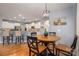 Bright dining area with hardwood floors adjacent to the modern kitchen at 104 Wingstem Ct, Mooresville, NC 28117