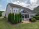 Exterior of a tan two story home with a screened in porch and green landscaping at 104 Wingstem Ct, Mooresville, NC 28117