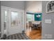 Inviting foyer with hardwood floors, a decorative rug, and a view of the dining room at 104 Wingstem Ct, Mooresville, NC 28117