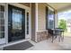 Welcoming front door with a covered porch, featuring outdoor seating and attractive exterior details at 104 Wingstem Ct, Mooresville, NC 28117