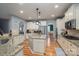 Spacious kitchen features granite countertops, an island, and stainless steel appliances at 104 Wingstem Ct, Mooresville, NC 28117