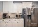 Bright kitchen featuring stainless steel refrigerator and stone countertops at 104 Wingstem Ct, Mooresville, NC 28117
