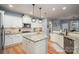 Spacious kitchen with stone countertops, wooden floors, and stainless steel appliances at 104 Wingstem Ct, Mooresville, NC 28117