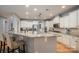 Modern kitchen with granite countertops, stainless steel appliances, and a breakfast bar at 104 Wingstem Ct, Mooresville, NC 28117