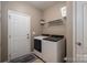Functional laundry room with modern washer and dryer units at 104 Wingstem Ct, Mooresville, NC 28117