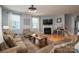Comfortable living room with a fireplace, large windows, and a cozy atmosphere at 104 Wingstem Ct, Mooresville, NC 28117
