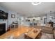 Open-concept living room with hardwood floors connecting to the kitchen and dining areas at 104 Wingstem Ct, Mooresville, NC 28117