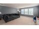 Spacious room with a modular couch and large windows, providing ample natural light and a relaxing atmosphere at 104 Wingstem Ct, Mooresville, NC 28117