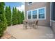A quaint patio area outside a home, furnished with a table and chairs, perfect for outdoor dining at 104 Wingstem Ct, Mooresville, NC 28117