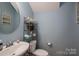 Charming powder room with stylish decor and a modern sink at 104 Wingstem Ct, Mooresville, NC 28117