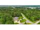 Aerial view of home with a large lot and surrounded by a beautiful treeline at 106 Pier Point Dr, Stony Point, NC 28678