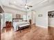 Main bedroom with tray ceiling, decorative ceiling fan, wood floors and natural light provides a relaxing retreat at 106 Pier Point Dr, Stony Point, NC 28678