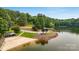 Scenic shot of boat ramp on peaceful lakefront nestled among verdant trees at 106 Pier Point Dr, Stony Point, NC 28678