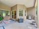 Inviting covered patio with an outdoor grill, seating, and easy access to the kitchen through sliding glass doors at 106 Pier Point Dr, Stony Point, NC 28678