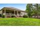 Charming back porch with white railings, ceiling fans, and access to a large backyard at 106 Pier Point Dr, Stony Point, NC 28678