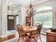 Cozy dining room with large windows, traditional wood furnishings, and an inviting ambiance for Gathering meals at 106 Pier Point Dr, Stony Point, NC 28678