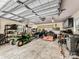 Spacious garage with ample storage, including a lawn tractor and various tools at 106 Pier Point Dr, Stony Point, NC 28678