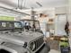 Spacious garage featuring parking for a Jeep and golf cart, with storage shelves at 106 Pier Point Dr, Stony Point, NC 28678
