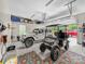 Bright, spacious garage featuring parking for a Jeep and golf cart, with an accent rug at 106 Pier Point Dr, Stony Point, NC 28678