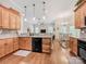 Well-lit kitchen with granite counters, wooden cabinets, and an open layout to the living and dining areas for easy entertaining at 106 Pier Point Dr, Stony Point, NC 28678