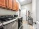 Modern laundry area includes a washer and dryer, storage cabinets, and plenty of room for folding and organizing laundry tasks at 106 Pier Point Dr, Stony Point, NC 28678