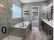 Luxurious bathroom featuring a soaking tub, a glass-enclosed shower and a vanity at 11211 James Coy Rd, Huntersville, NC 28078