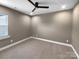 A carpeted bedroom features a ceiling fan and a large window at 11211 James Coy Rd, Huntersville, NC 28078