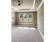 Neutral bedroom with recessed lighting and large windows; blinds half-drawn at 11211 James Coy Rd, Huntersville, NC 28078