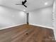 Bedroom boasts dark wood floors, a ceiling fan, and natural light at 11211 James Coy Rd, Huntersville, NC 28078