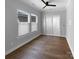 Bright bedroom with wood floors, a ceiling fan, sliding glass doors, and large windows with blinds at 11211 James Coy Rd, Huntersville, NC 28078
