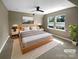 This cozy bedroom features a ceiling fan, carpet, and natural light from dual windows at 11211 James Coy Rd, Huntersville, NC 28078