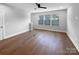 Bedroom featuring wood floors, a ceiling fan, and large windows at 11211 James Coy Rd, Huntersville, NC 28078