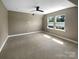 Bedroom featuring neutral carpet, two windows, and fresh paint at 11211 James Coy Rd, Huntersville, NC 28078