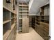 Custom closet features wooden shelving, drawers, and cabinets to maximize storage space at 11211 James Coy Rd, Huntersville, NC 28078