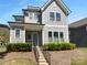 Charming two-story home with blue door, inviting front porch and manicured landscaping at 11211 James Coy Rd, Huntersville, NC 28078